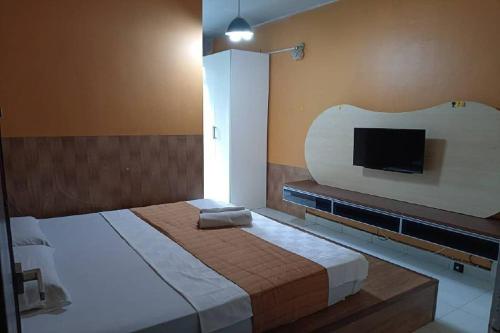 a bedroom with a large bed and a flat screen tv at Aeon Tebrau Apartment Johor Bahru - By Room - in Johor Bahru