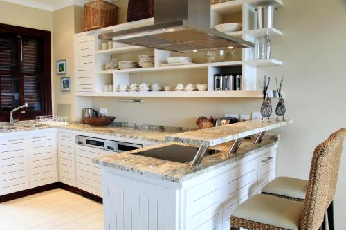 a kitchen with a sink and a counter top at Eden Island Luxury Accommodation in Eden Island