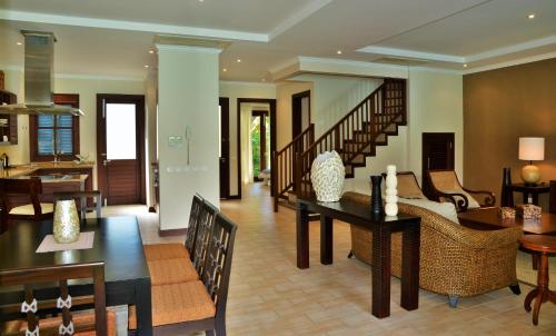 a dining room and living room with a dining table at Eden Island Luxury Accommodation in Eden Island