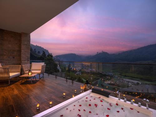 a balcony with a view of the mountains at The Golden Ridge Hotel in Nuwara Eliya