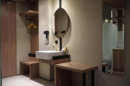 a bathroom with a sink and a mirror at Posto Dormire Sudirman in Jakarta