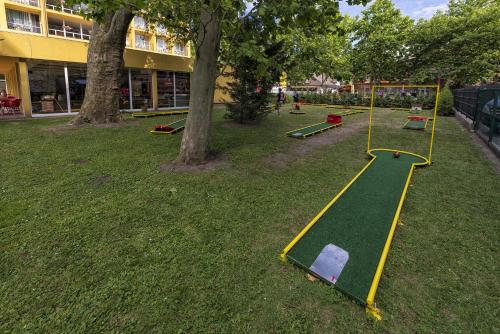 a park with a play area in the grass at Hotel Lido in Siófok