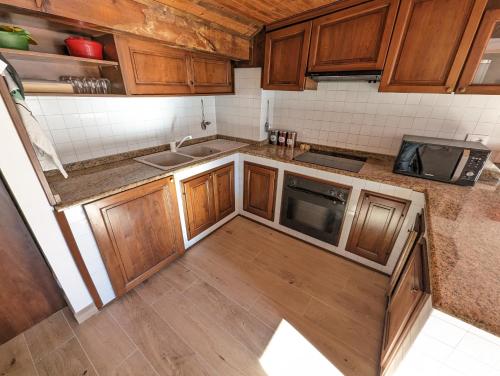 an overhead view of a kitchen with wooden cabinets at Mansarda con vista panoramica Limone Piemonte in Limone Piemonte