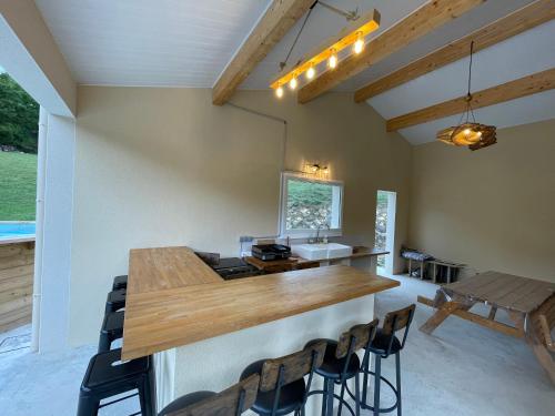 a kitchen with a large wooden table and chairs at Au Mas du Bec Pointu entre DIOIS et PROVENCE in Eygluy