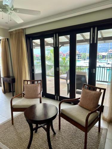 a living room with two chairs and a table at Eden Island Luxury Accommodation in Eden Island