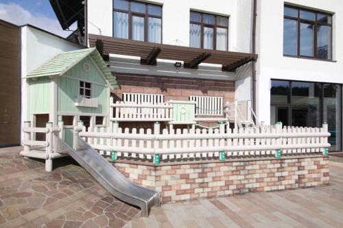 a playground with a slide in front of a house at MORVA Premium Spa Resort in Yaremche