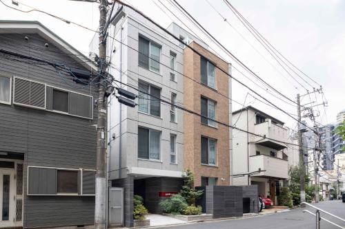 a building on a city street with power lines at Quador Waseda in Tokyo