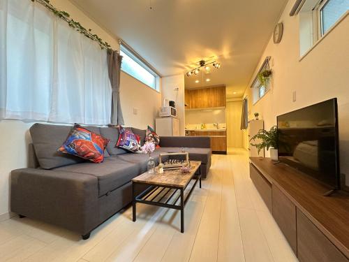 a living room with a couch and a coffee table at nestay villa tokyo sugamo in Tokyo