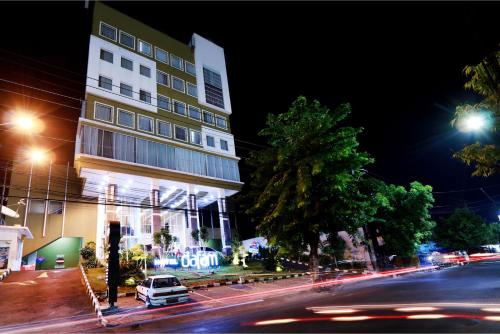 a building on the side of a street at night at Hotel Dafam Pekalongan in Pekalongan