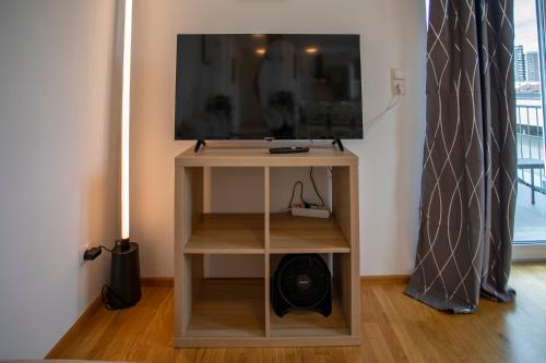 a television on a stand in a room at Innsbruck East Side Apartment I Free Street Parking in Innsbruck