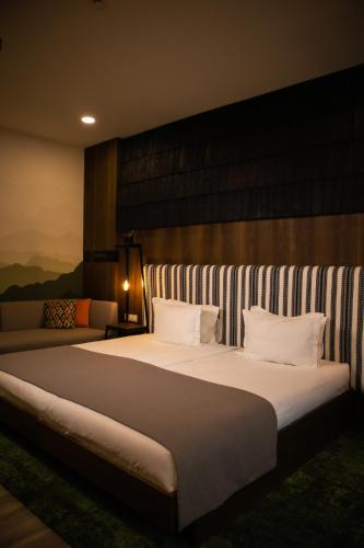 a large bed with white pillows in a room at MORVA Premium Spa Resort in Yaremche