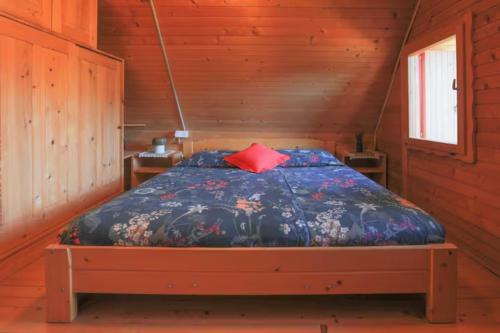 a bedroom with a bed in a wooden cabin at Pravlca (Fairytale Cottage) in Zgornje Gorje