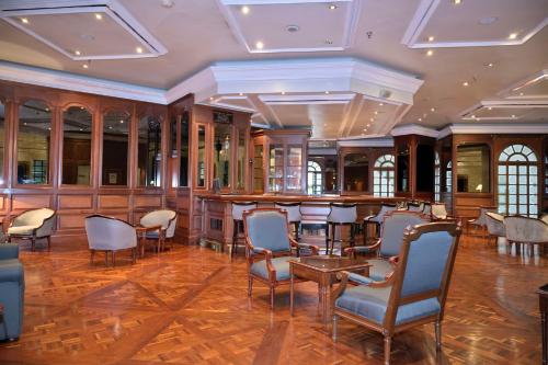 a bar in a room with chairs and tables at Meliá Caracas in Caracas