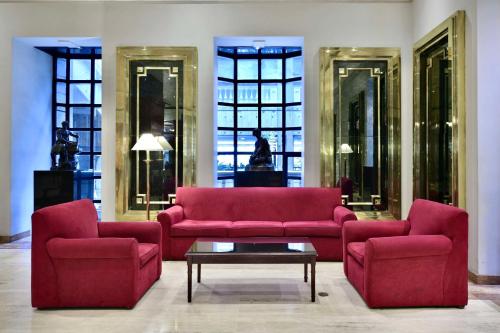 a living room with two red couches and a table at Meliá Caracas in Caracas