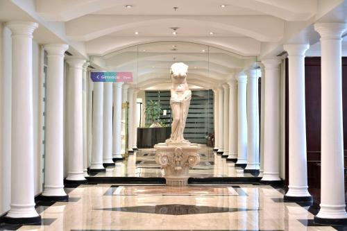 a statue in the middle of a building with columns at Meliá Caracas in Caracas