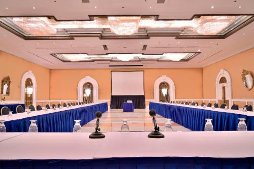 a banquet hall with blue tables and a screen at Meliá Caracas in Caracas