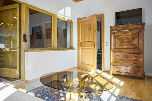 a room with a glass table and a dresser at Alt Montafon Hotel Appartements by Pferd auf Wolke in Gaschurn