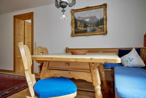 a dining room with a wooden table and chairs at Alt Montafon Hotel Appartements by Pferd auf Wolke in Gaschurn