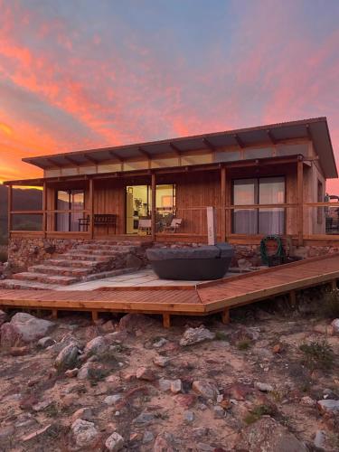 een huis met een groot bad op een houten terras bij Riverbend Farm in Robertson