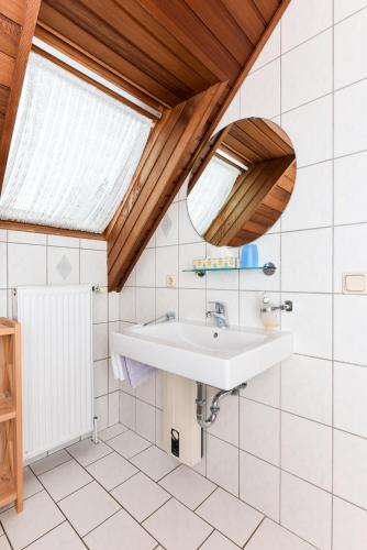 a bathroom with a sink and a skylight at Ferienhaus Sonny in Carolinensiel