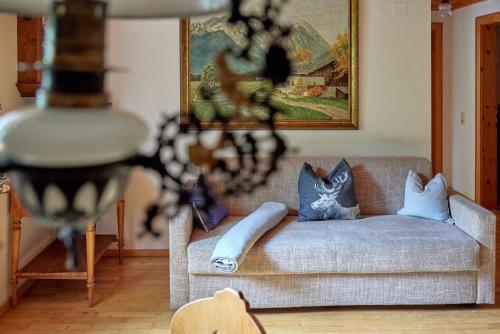 a living room with a couch with blue pillows at Alt Montafon Hotel Appartements by Pferd auf Wolke in Gaschurn