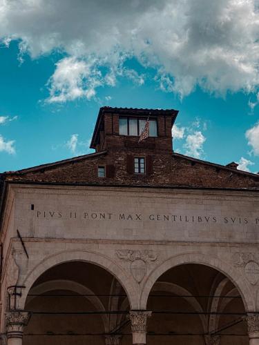 a brick building with a flag on top of it at B&B Le Logge Luxury Rooms in Siena