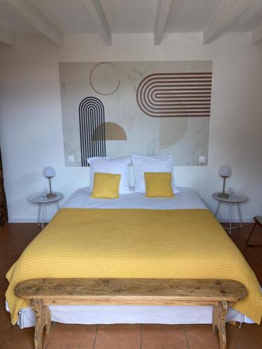 a bedroom with a large bed with yellow pillows at Casa Santa Giulia in Propriano