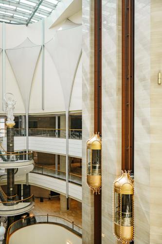 a lobby with two chandeliers in a building at Lotte Hotel World in Seoul