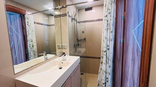 La salle de bains est pourvue d'un lavabo et d'un miroir. dans l'établissement Laguna Beach Resort 2 Jomtien, à Jomtien Beach