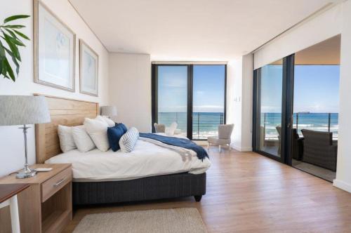 a bedroom with a bed with a view of the ocean at Sea La Vie - with Inverter in Umdloti