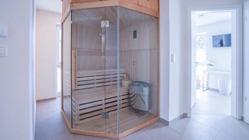 a glass enclosure in a room with a toilet at Ferienhaus - EMILY in Burhave