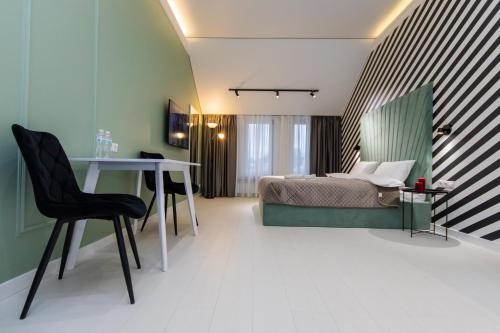 a bedroom with a bed and a table and a desk at LUX Апартаменти MYFREEDOM поруч метро Театральна, Хрещатик in Kyiv