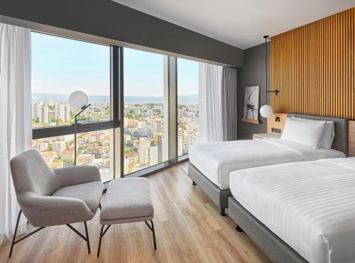 a hotel room with two beds and a chair at AC Hotel by Marriott Split in Split