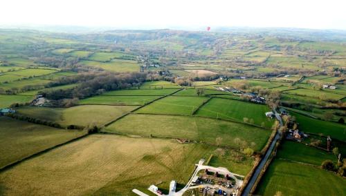 an aerial view of a field with a castle at Poplars Farm Adults only Touring Site empty pitches in Ireton Wood