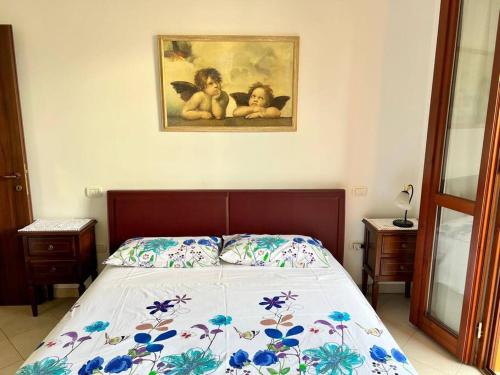 a bedroom with a bed with two dolls on it at Casa Corinaldesi in Marotta