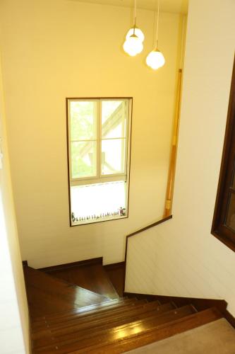 an empty room with a staircase and a window at ALBERGO DEL PESCATORE in Minamiaizu