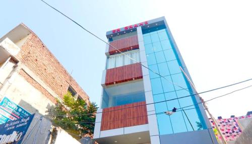a tall building with red and blue windows at HOTEL SR GRAND in Gorakhpur