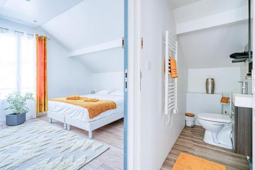 a white bedroom with a bed and a toilet at Greg & Theo's in Fontenay-sous-Bois