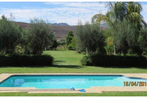 a swimming pool in the middle of a yard at Blue Mountain View Cottages in Clanwilliam