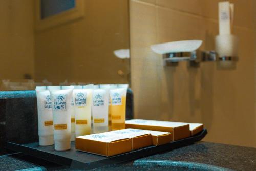a bunch of toiletries on a counter in a bathroom at Ajyal Al Madinah La Cordia Hotel Apartment in Medina