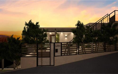 a building with a fence and trees in front of it at Princess of Axos Luxury Suites in Axós
