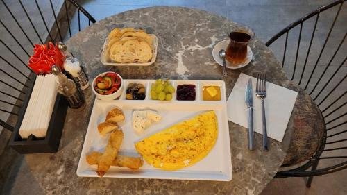 a table with a plate of breakfast food on it at Jurnal Hotel in Istanbul