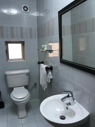a bathroom with a white toilet and a sink at EEM Only Girls Student Residence in Is-Swieqi