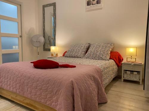 une chambre avec un lit avec un oreiller rouge dessus dans l'établissement Appart Cocoon / Rue Porte Dijeaux, à Bordeaux
