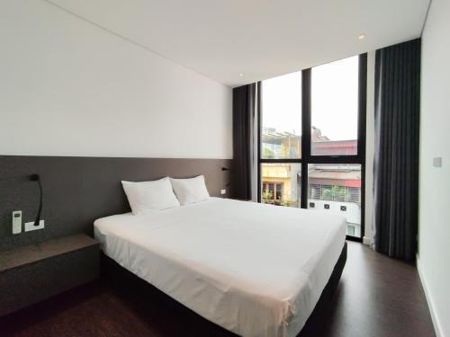 Een bed of bedden in een kamer bij Nikomix - Hazuki Apartment 03