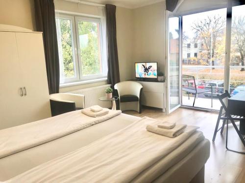 two beds in a room with a large window at Fresh house in Prague