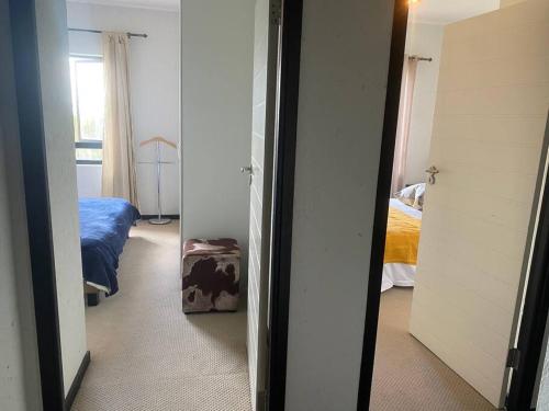 a room with a bedroom with a bed and a mirror at Lustrous Loft Living in Penthouse in Roodepoort