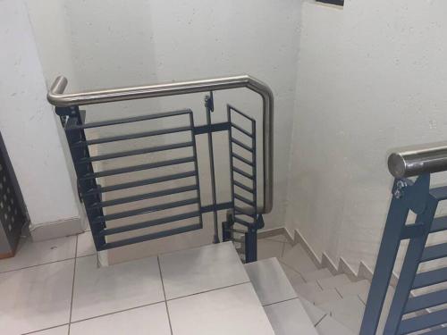 a staircase with a metal railing in a bathroom at Lustrous Loft Living in Penthouse in Roodepoort