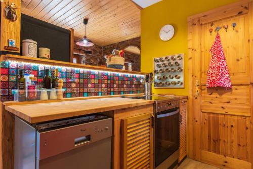 a kitchen with a christmas tree on the wall at The Pirates Lodge Milina - Chill-out in Strandnähe in Milína