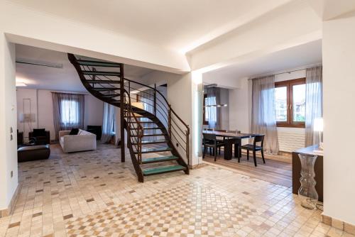 a living room with a spiral staircase and a dining room at Set of Flats Vol 1 2 3 in Tríkala